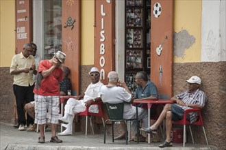 Men sitting in the Lisboa Cafe in the historic centre of Mindelo