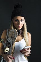 Cool young woman with a skateboard