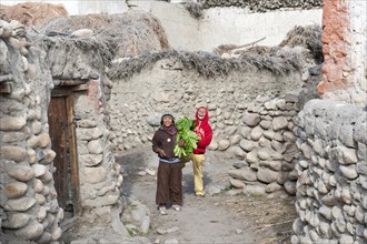 Cheerful children in a village between old walls