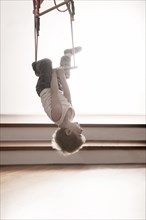 Young boy exercising on a swing