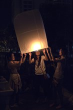Young people releasing a sky lantern or Kongming lantern