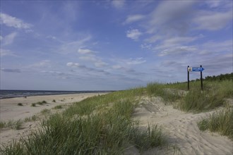 Sandy beach on the Baltic Sea with sign for a cafe