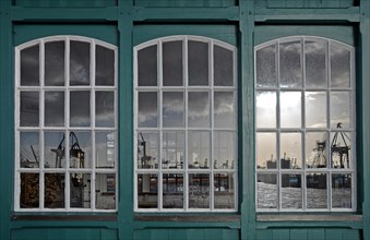 Reflection of a harbour scene in an old boat shed