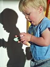 Young boy holding pieces of chalk