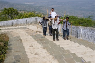 Porters carrying a Jain pilgrim up Mount Shatrunjaya