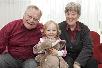 Grandparents with their granddaughter