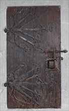 Medieval wooden door with ornate ironwork