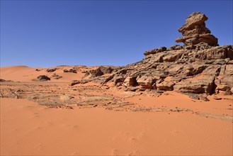 Sandstone rock towers and sand dunes at Tin Merzouga