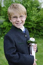 Boy holding a First Communion candle