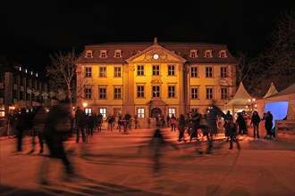 Skating rink with skaters on the market square at night