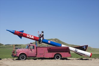 A missile mounted on an antique fire truck