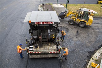 Tarmac laying machine at a large inner-city road construction site