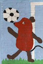 Mouse figure playing football