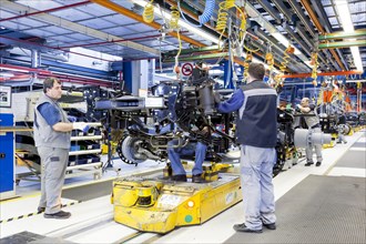 Employees assembling a chassis at MAN Truck and Bus AG