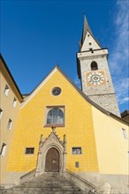 Yellow painted church with a bell tower