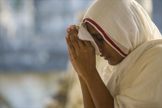 A Jain nun praying at a temple