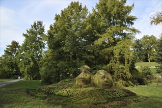 Stone statues overgrown with moss