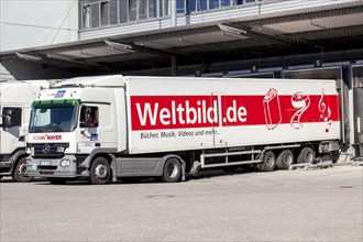 A truck of the Weltbild Publishing Group parked in front of the logistics centre of Weltbild Verlag