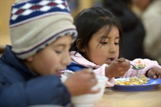 Children eating in the cafeteria of their school