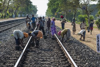 Labourers are maintaining railway tracks