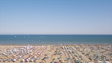 View of a beach with sunshades and sun beds in the afternoon