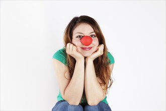 Young woman with clown nose