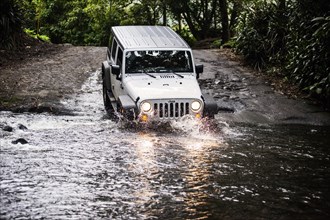 Jeep crossing a stream in Waipio Valley