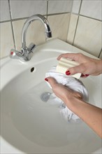 Washing by hand with German curd soap in a washbasin
