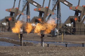 Natural gas is flared off as oil is pumped in the Bakken shale formation