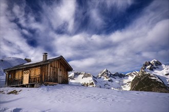 Alpine hut in a mountain landscape in winter