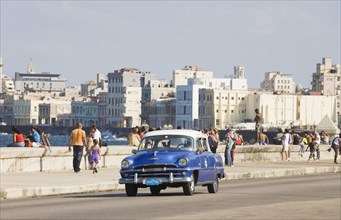 1954 Plymouth driving on the Malecon esplanade
