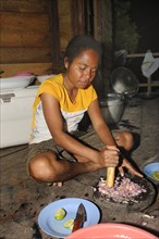 Papuan woman preparing food