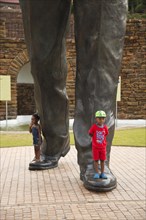 Children at the feet of the huge Nelson Mandela statue in front of the Union Buildings government buildings