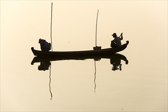 Fishermen in their boat in the morning light