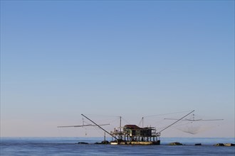 Fisherman's house with nets over the sea in Marina di Pisa