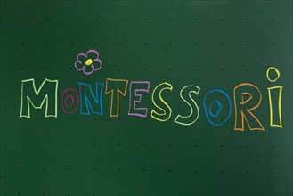 Montessori' written with chalk on a blackboard