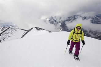 Snowshoe hiker on the summit ridge of Schoenalmjoch in the Karwendel Mountains