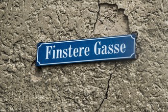 Street sign Finstere Gasse or Dark Alley