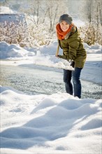 Woman shovelling snow