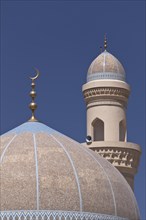 Mosque with a golden crescent moon and a minaret