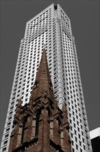 Old tower of the Presbyterian Church in front of a skyscraper