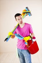 Man holding cleaning products in his hands