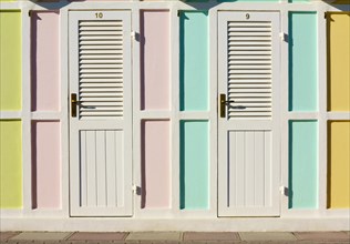 Pastel coloured beach cabins