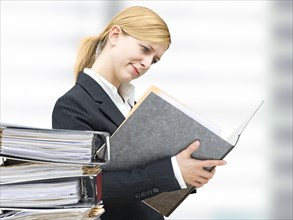 Young business woman reading in a folder