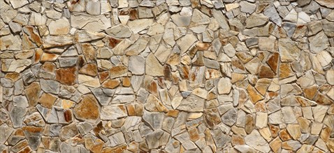Wall of many beige natural stones