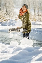 Woman shovelling snow