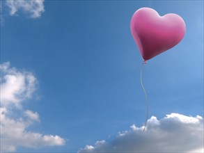 Pink balloon in heart shape against blue sky with clouds