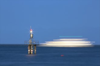 Evening mood with a with moving ship at the Hoernle Lighthouse