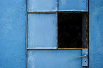 Blue-painted door with a window