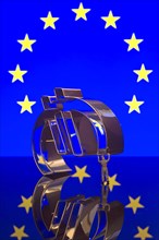 Miniature figure of a worker is carrying the Euro-symbol